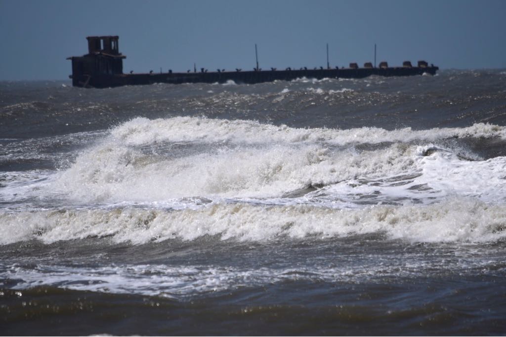 Al fondo, el muelle de Puerto Colombia, soportando el fuerte oleaje en el Caribe.