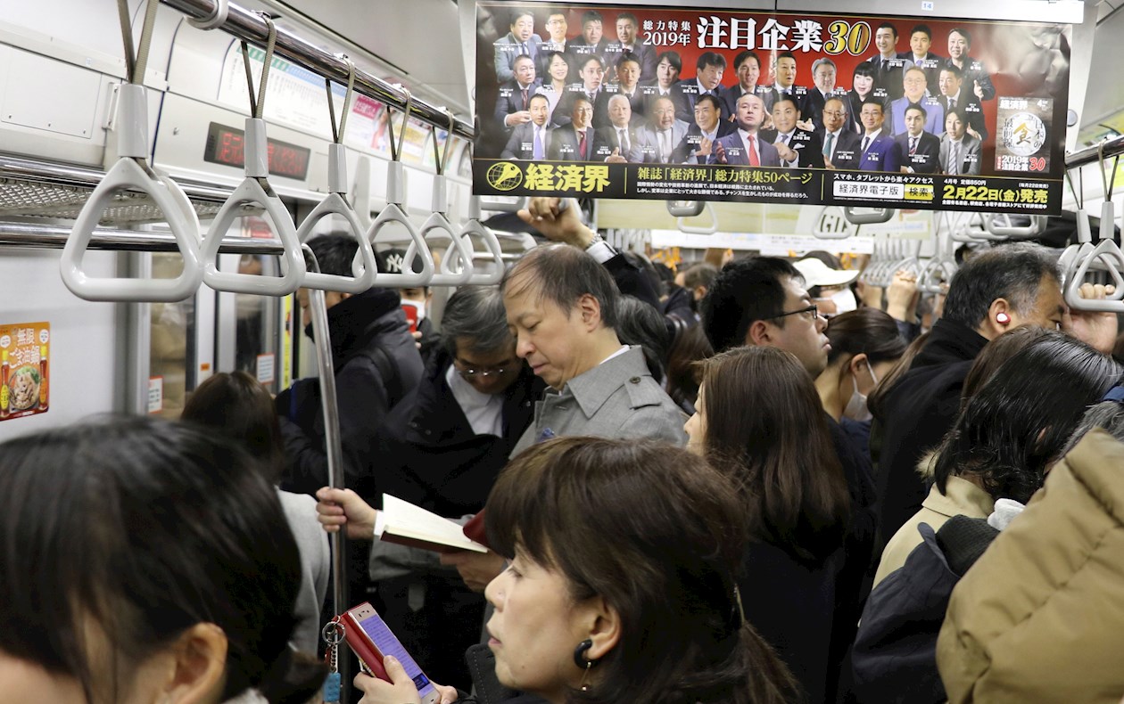 Decenas de personas se agolpan los vagones de metro de Tokio.