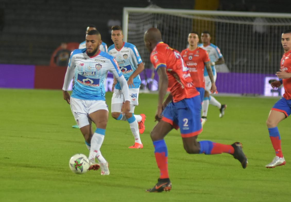 El volante Freddy Hinestroza en un ataque de Junior ante la marca de Anier Figueroa.