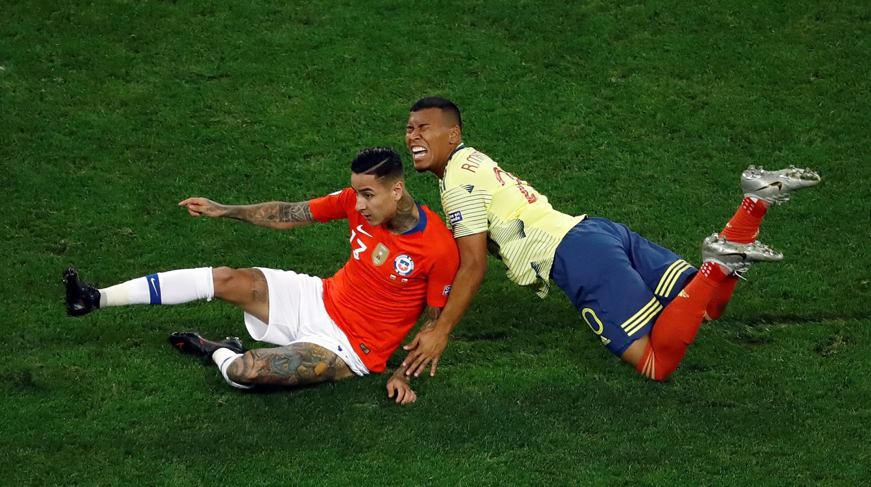 Roger Martínez disputa el balón con Erick Pulgar de Chile.