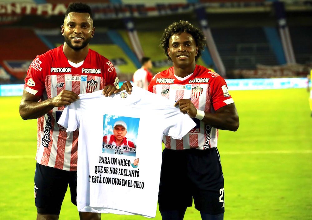 Miguel Ángel Borja y Fabián Viáfara homenajeando a un aficionado fallecido.
