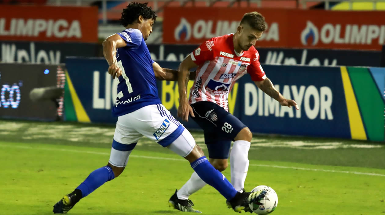 Juan David Rodríguez disputando el balón con Juan Carlos Pereira.