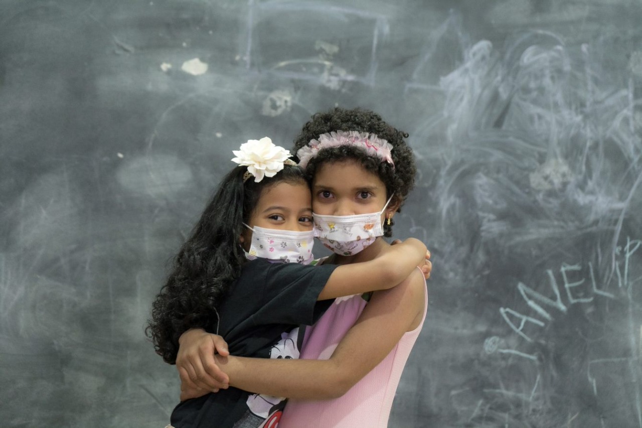 Ivanna y Angely se abrazan en su estadía en la Fundación la Divina Providencia, 