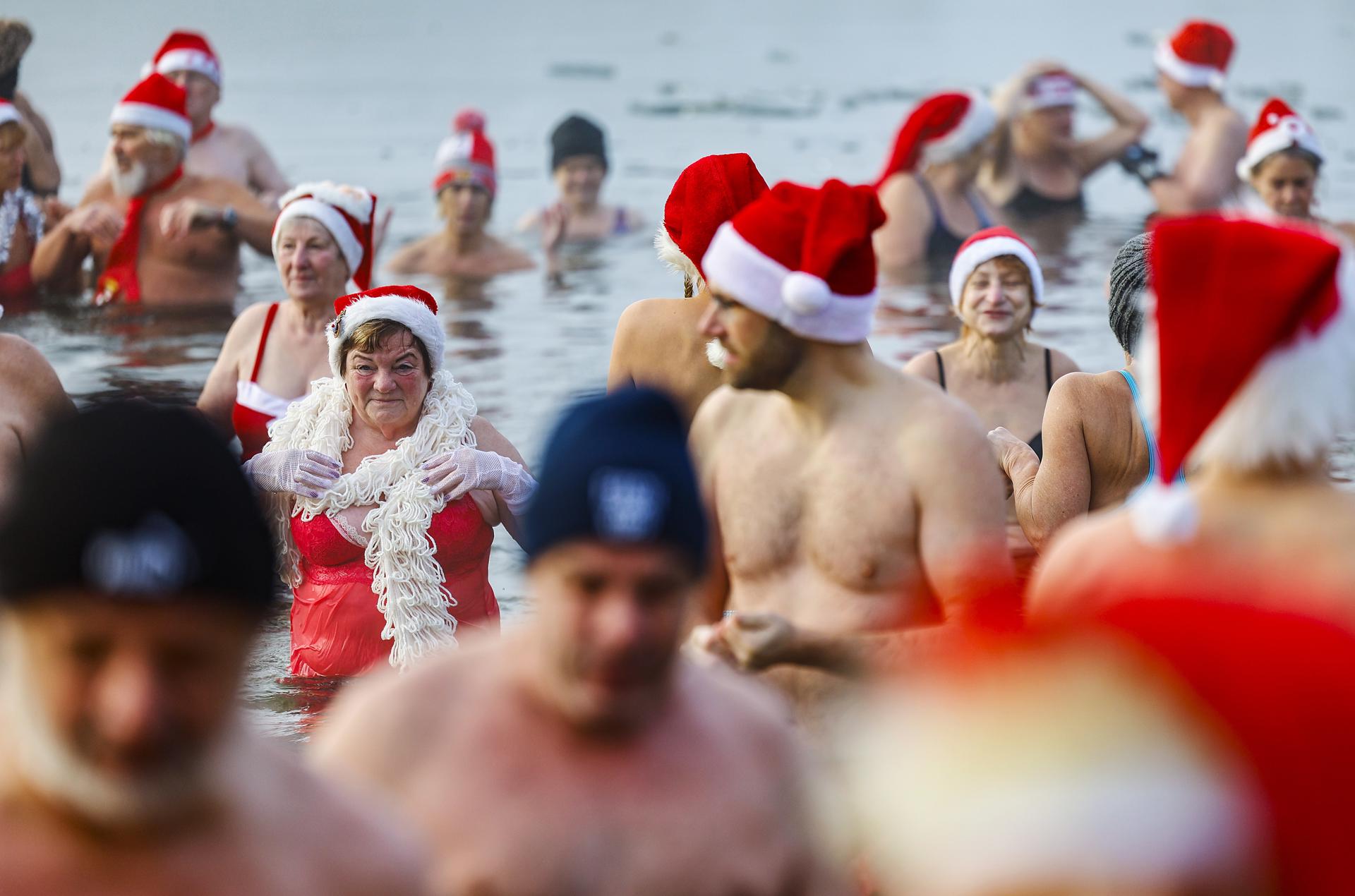 Los miembros del club 'Berlin Seals' asisten al tradicional baño navideño en el lago Oranke en Berlín, Alemania.