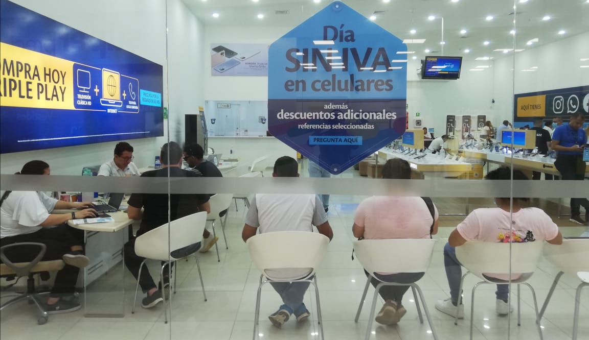 Clientes aguardan en un almacén de telefonía celular