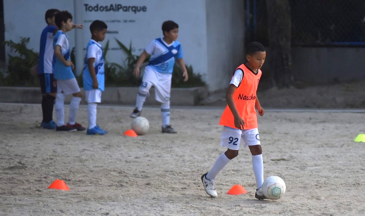 Niños practicando fútbol.