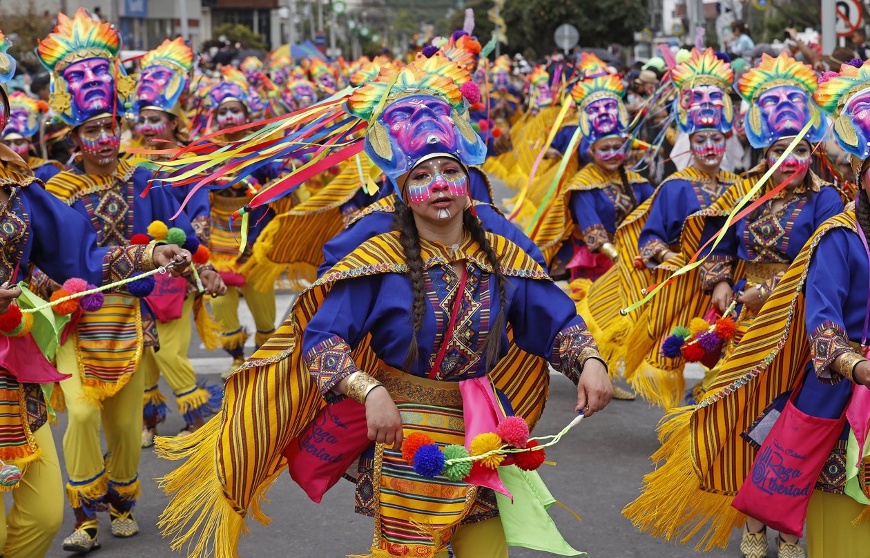 Personas participan en el desfile de los colectivos coreográficos en tributo a la Madre Tierra durante el Carnaval de Negros y Blancos.