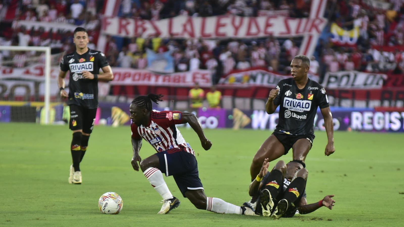 Yimmi Chará, de discreto partido, se libra de la marca de un jugador del Pereira. 