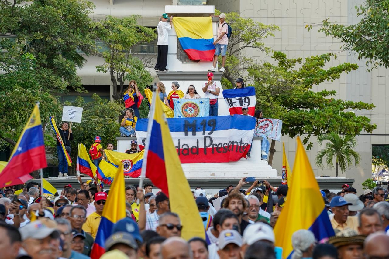 Banderas del M–19 colgadas junto a la estatua de Bolívar.