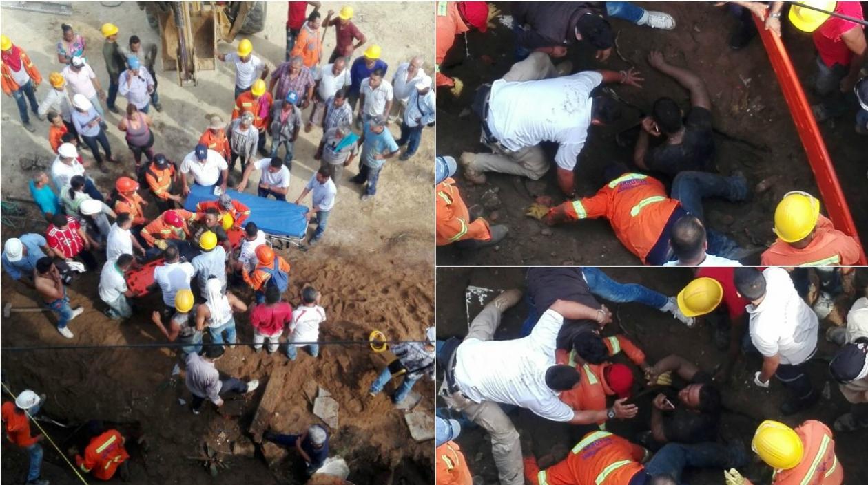 Momentos en que los dos obreros son auxiliados por sus compañeros en el lugar donde ocurrió el hecho en la calle 76 con carrera 48.