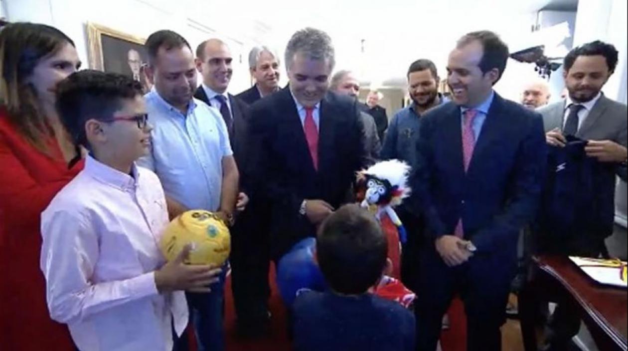 El Presidente Iván Duque entrega un Baqui de peluche al pequeño Cristo José. 