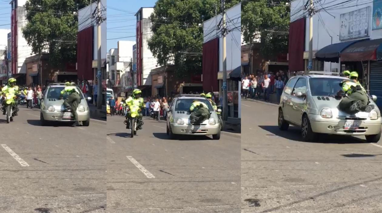 Aferrado en el capó el patrullero logró salvarse pese a que la conductora continuaba su marcha.