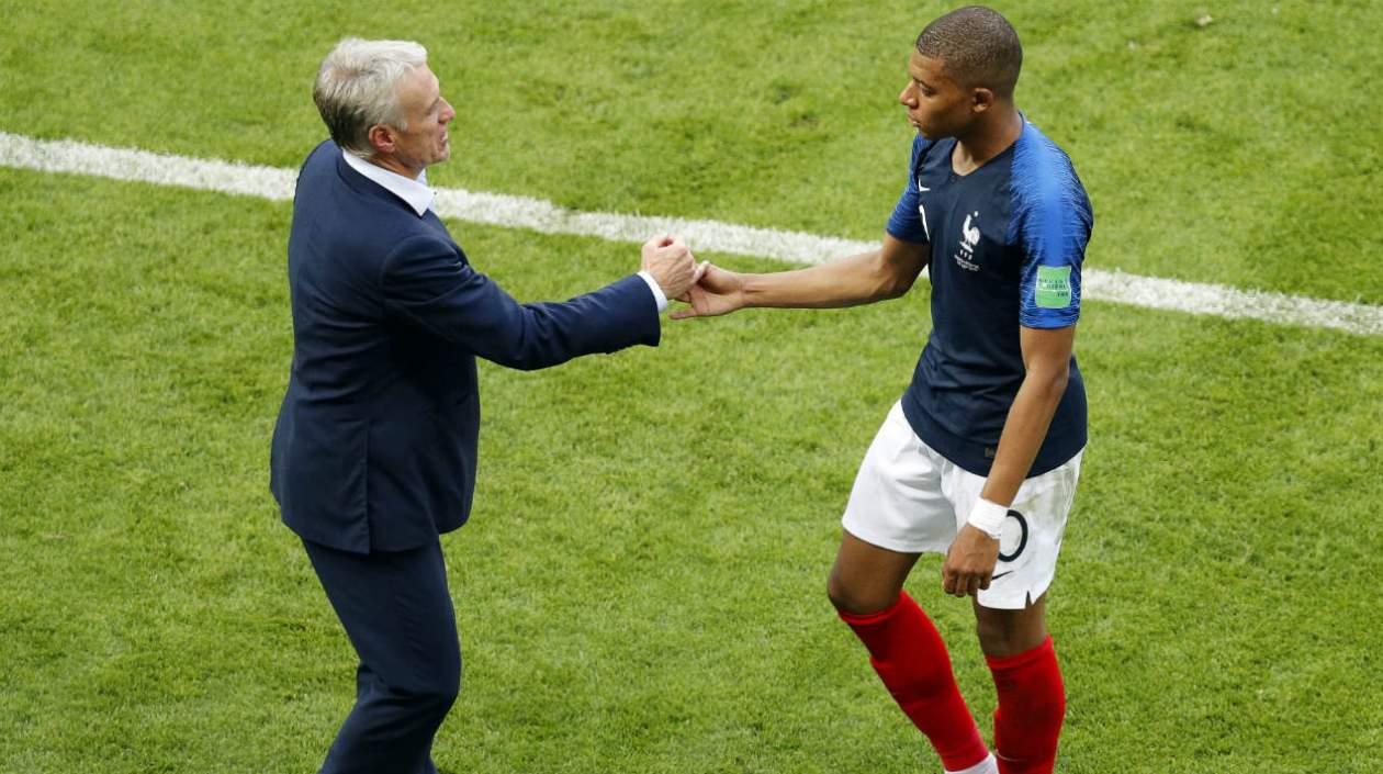 Kylian Mbappe se saluda con su técnico Didier Deschamps.