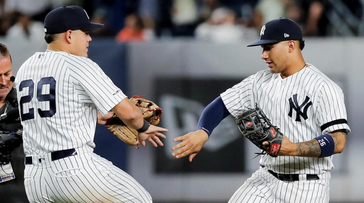 Giovanni Urshela y Gleiber Torres celebran la victoria en un partido.