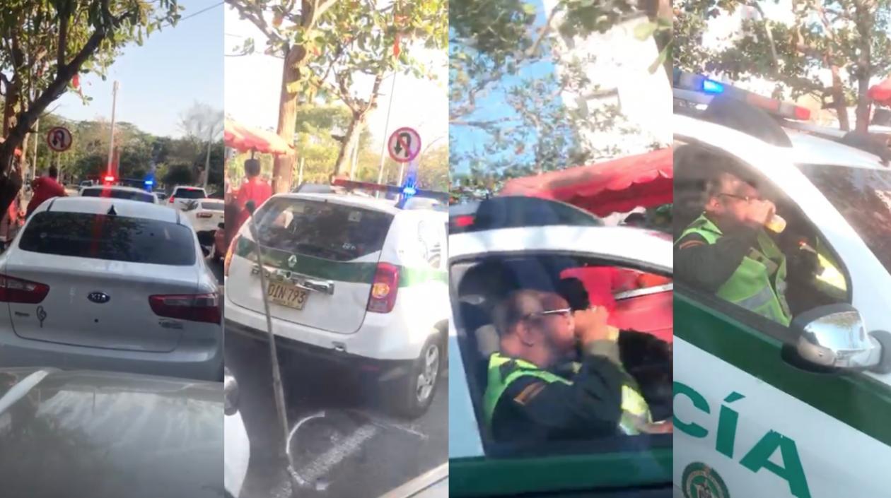 Los dos policías comprando fritos en espacio público de Barranquilla.