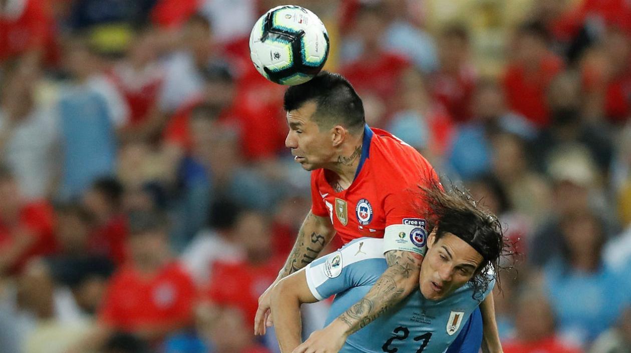 Gary Medel disputa la pelota con Edison Cavani. 