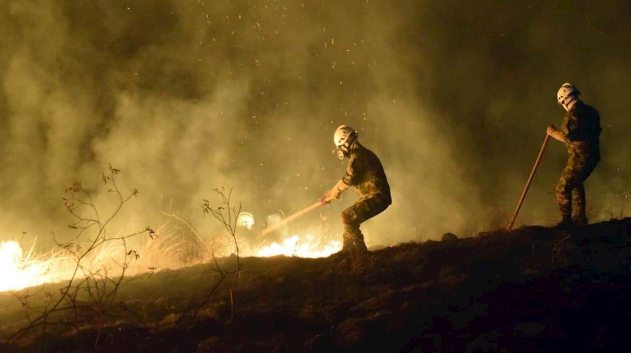 Fotografía del 21 de agosto de 2019 cedida por el Ejército de Colombia muestra soldados combatiendo un incendio en La Mata, departamento de Huila (Colombia).