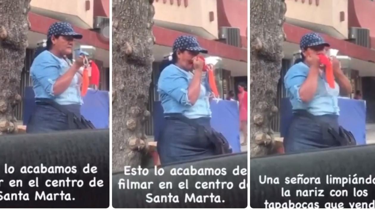 La mujer limpiándose la nariz.