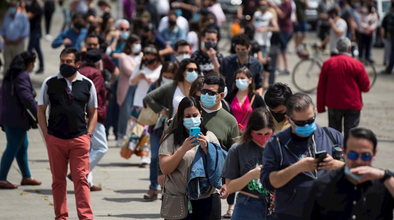 Chilenos acuden al Estadio Nacional, donde se habilitaron mesas de votación, para ejercer su derecho al voto en el plebiscito este domingo en Santiago (Chile).