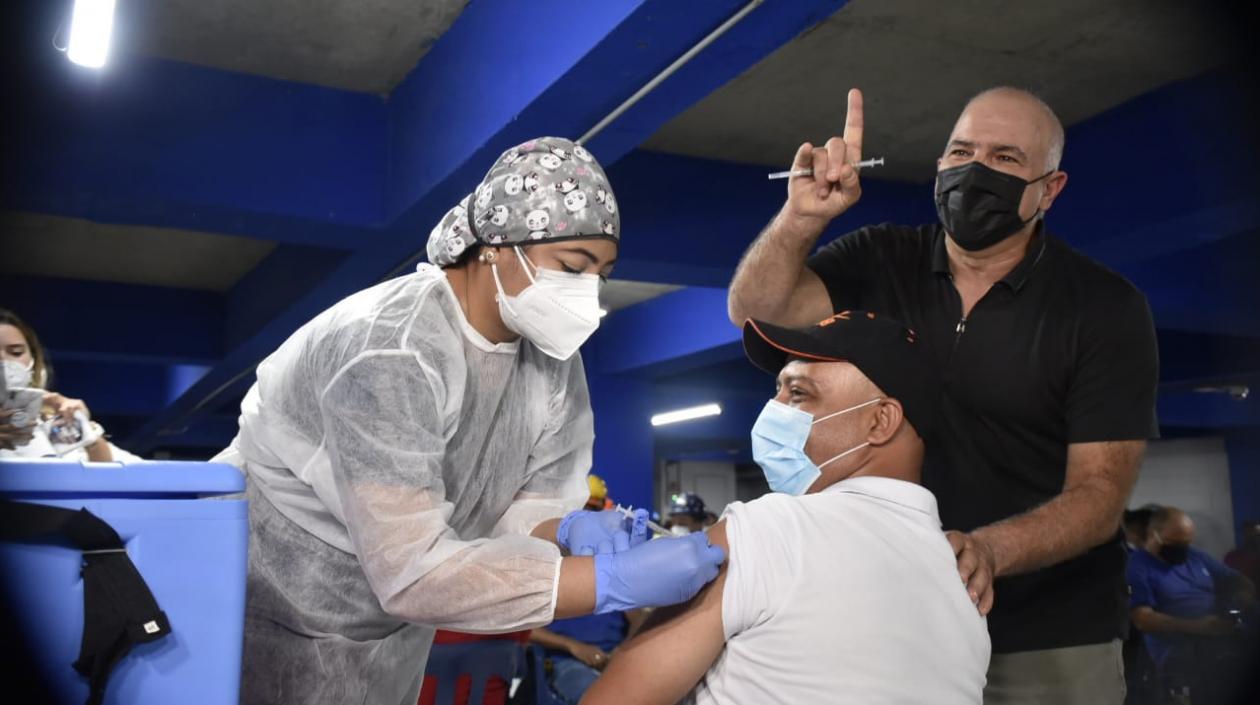 El COO Christian Daes observa al primer trabajador de Tecnoglass vacunado..