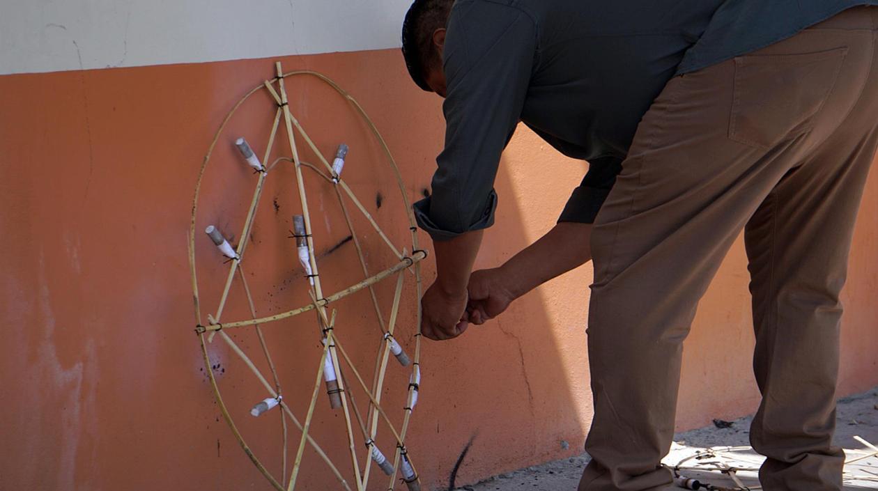 Un hombre enciende una rueda pirotécnica con motivo del Día de Muertos en Mitla, estado de Oaxaca.