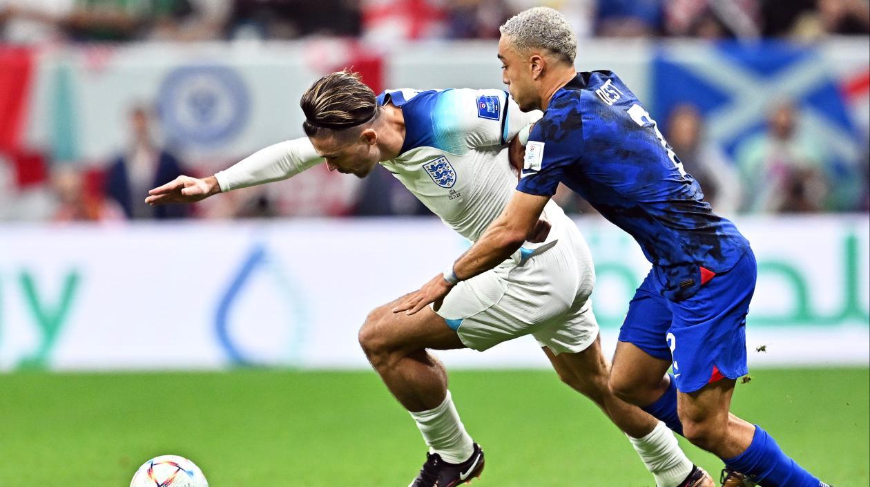 Jack Grealish avanza ante la marca de Sergino Dest.