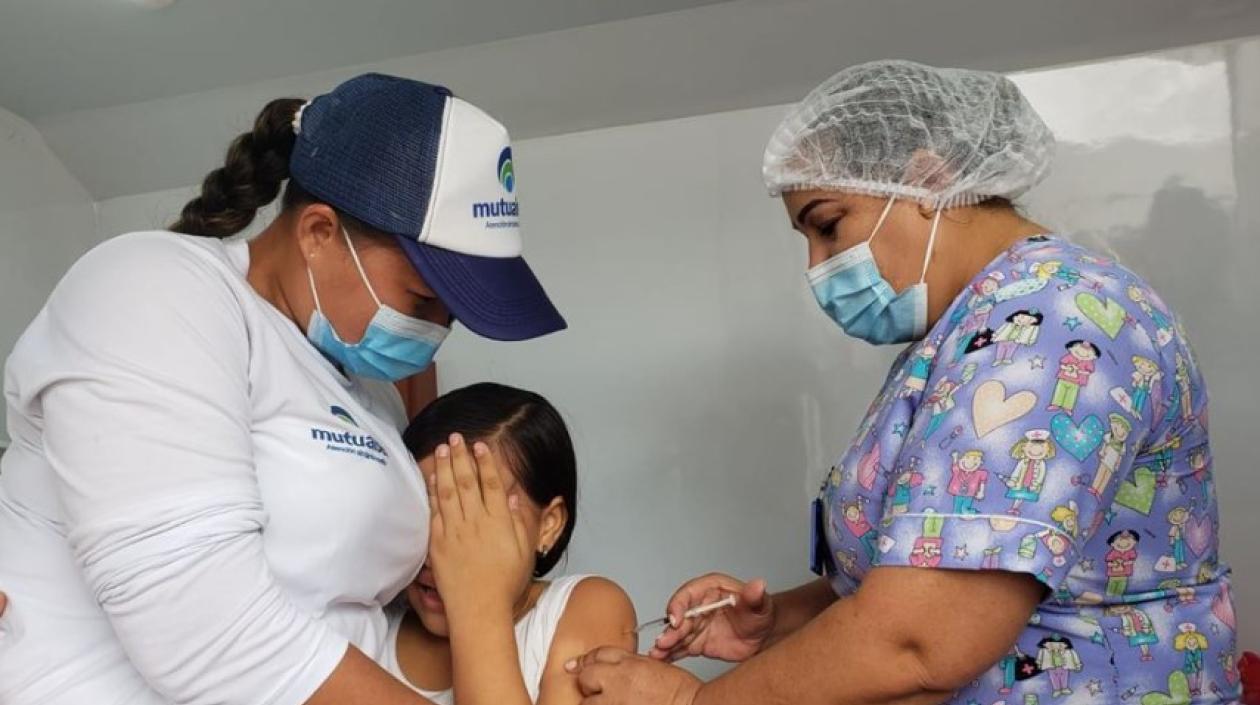 Una funcionaria de salud vacuna a una niña sucreña contra Covid-19.