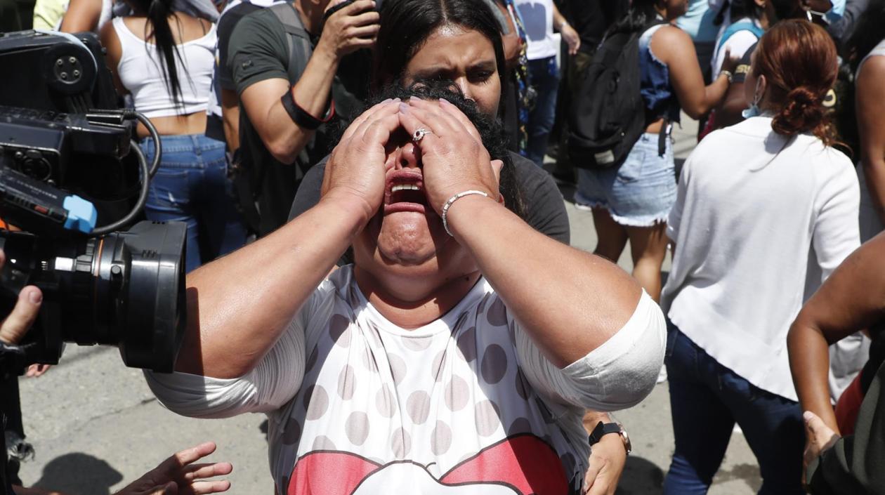 Una mujer llora mientras familiares y amigos de reclusos intentan saber el estado de salud de los detenidos de la cárcelde Tuluá.