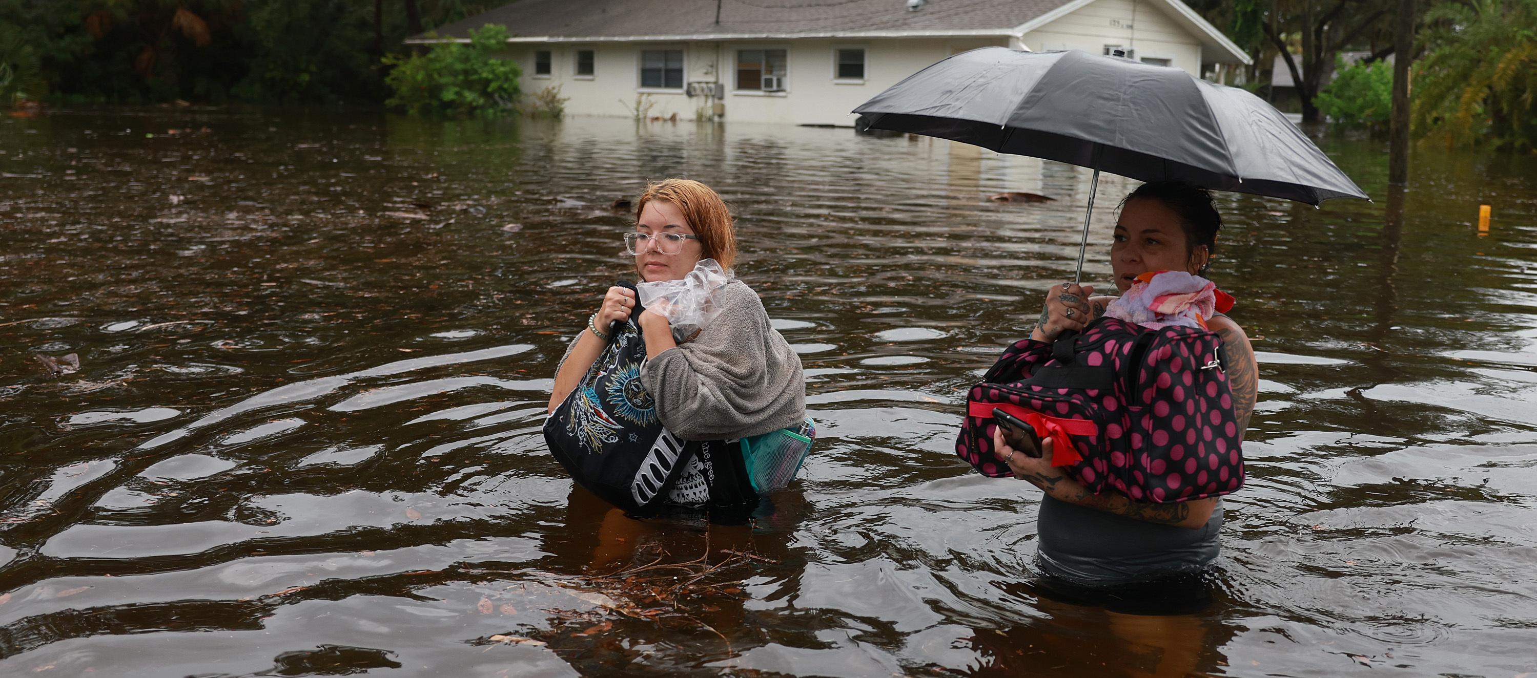 Dos mujeres caminan entre las inundaciones que dejó 'Idalia' a su paso por Florida