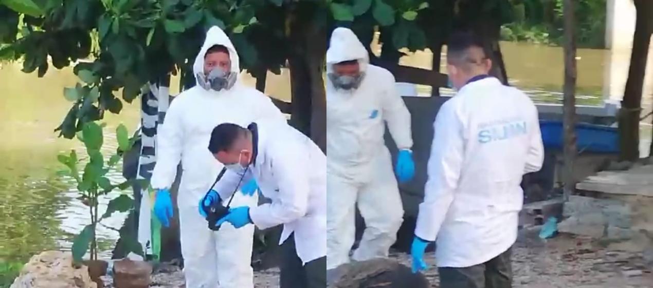 La Sijin realizando la inspección del cuerpo a orillas del río Magdalena. 