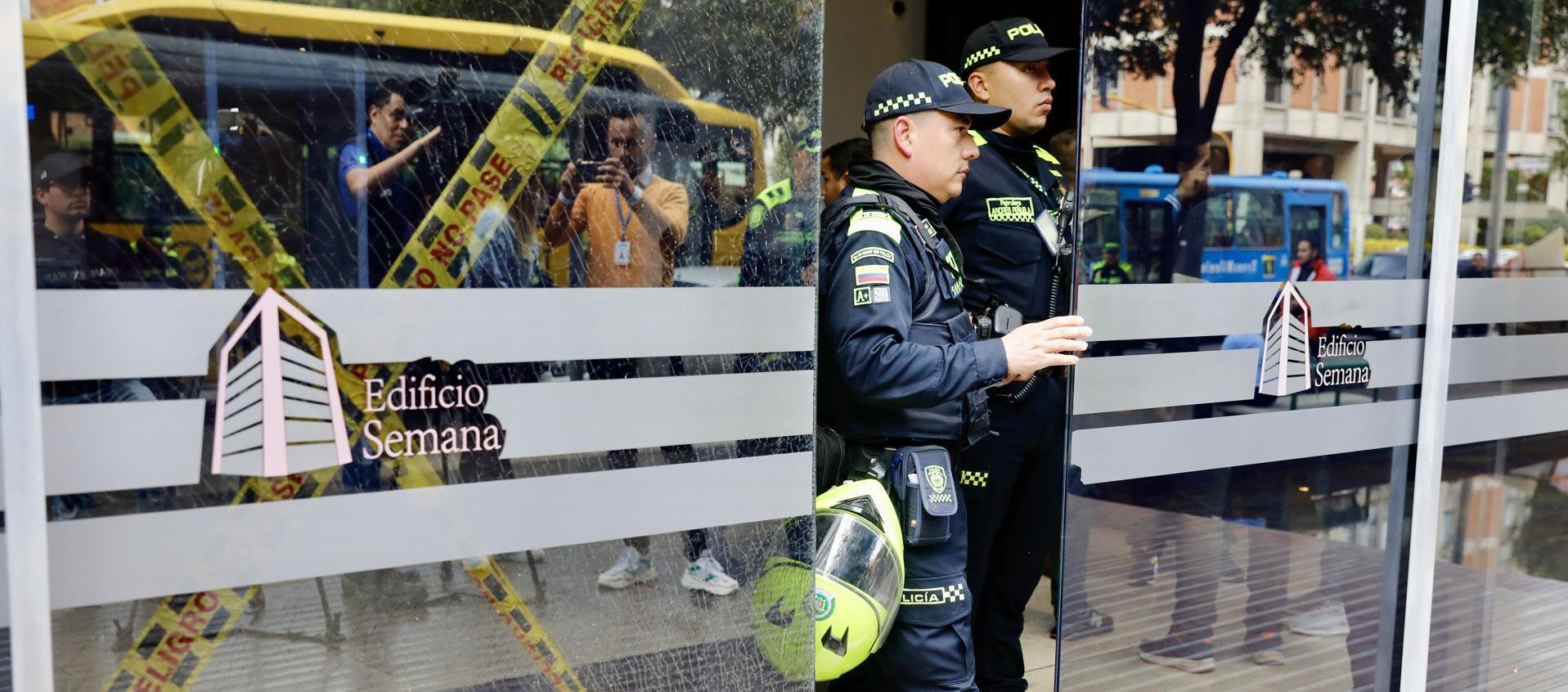 Integrantes de la Policía permanecen en la entrada del edificio donde funciona la revista Semana.