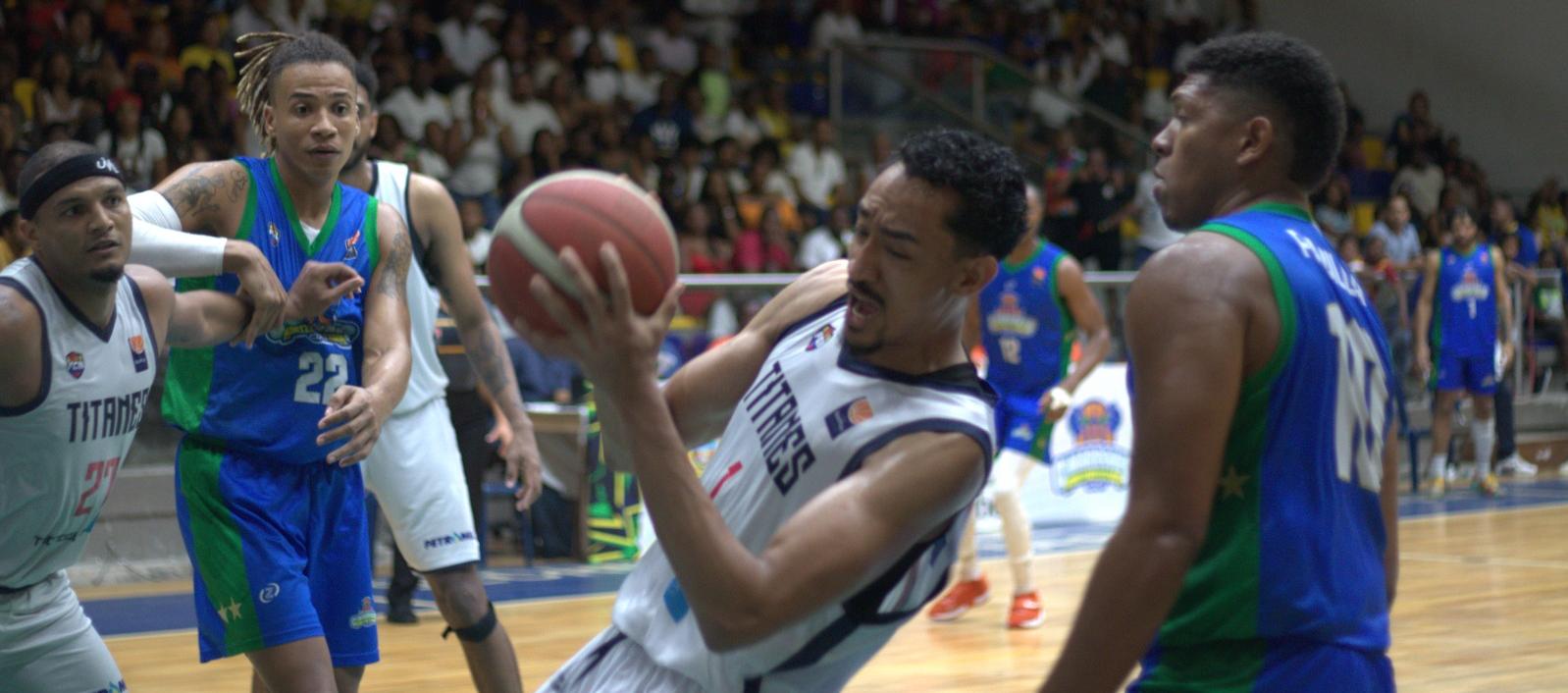 Juan Cárdenas, de Titanes, se apodera de la pelota durante el juego contra Cimarrones. 
