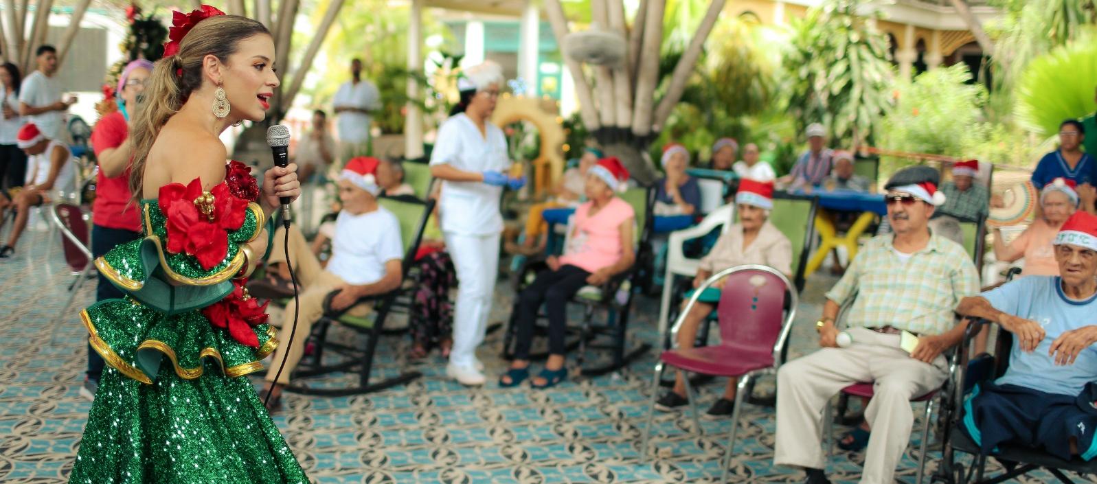 La soberana del Carnaval con los abuelitos del Centro San Camilo. 