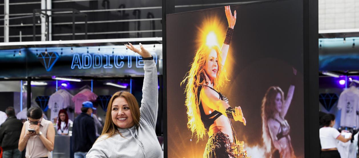 Una seguidora de Shakira posa junto a una foto de la cantante barranquillera. 