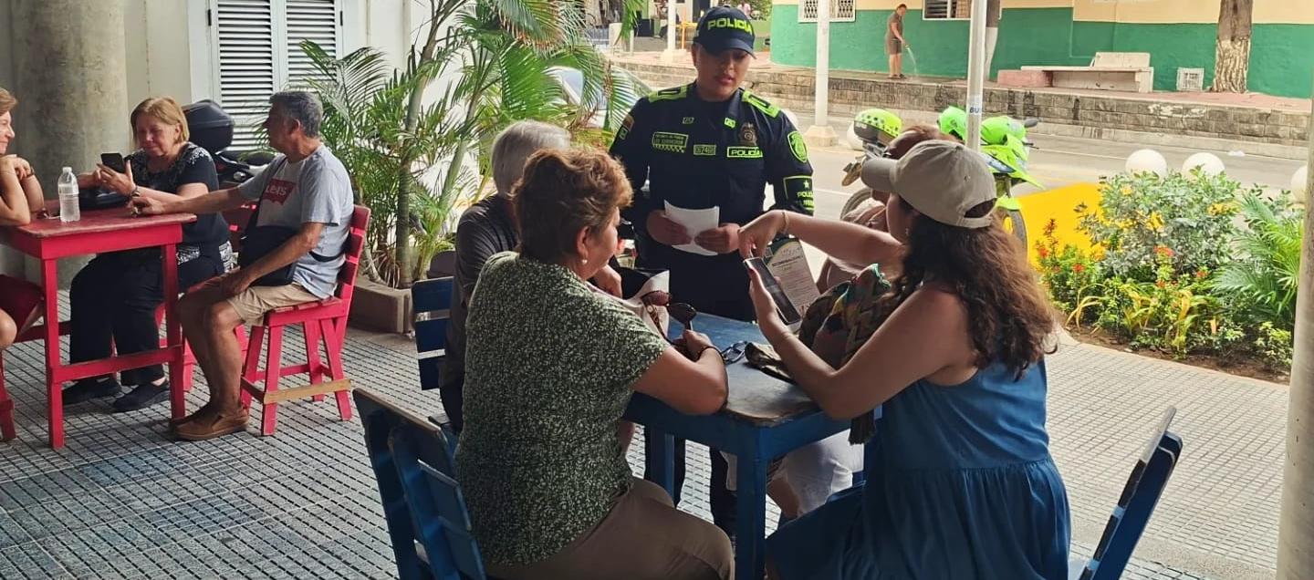 Uniformados de la Policía con visitantes en el Museo del Carnaval. 