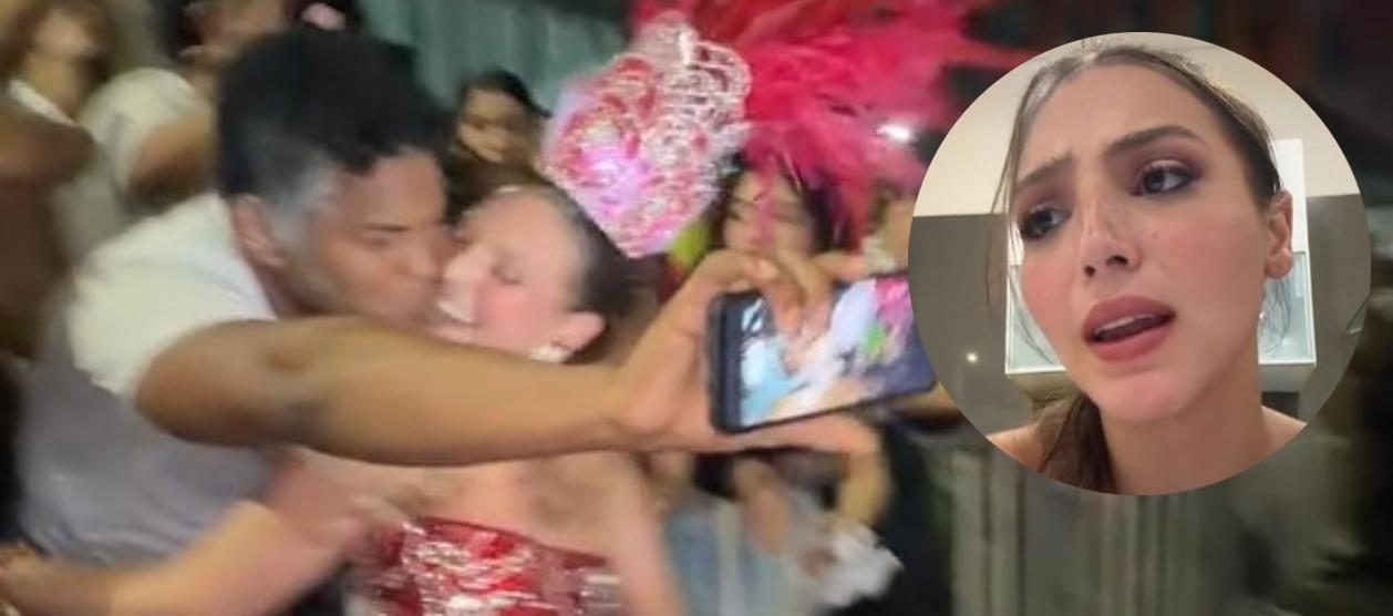 Momento del beso y la imagen de la Reina.