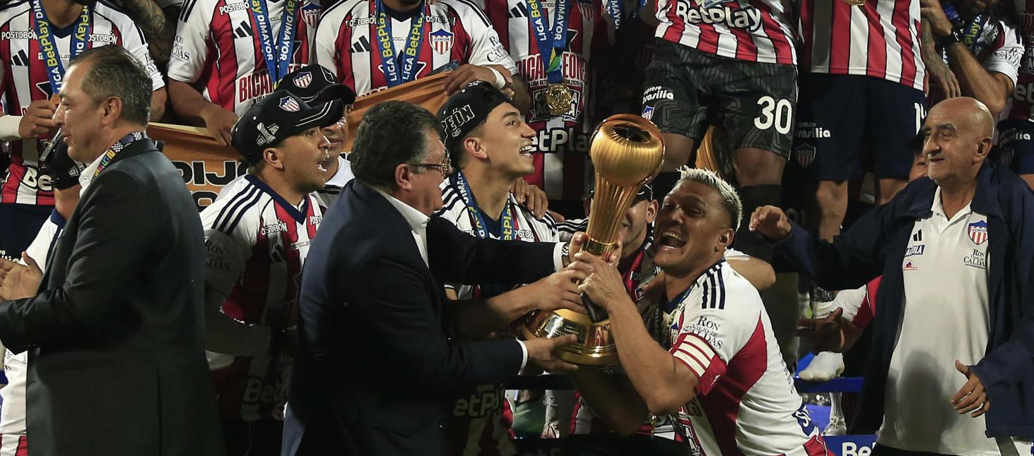 Teófilo levantando el trofeo de campeón.