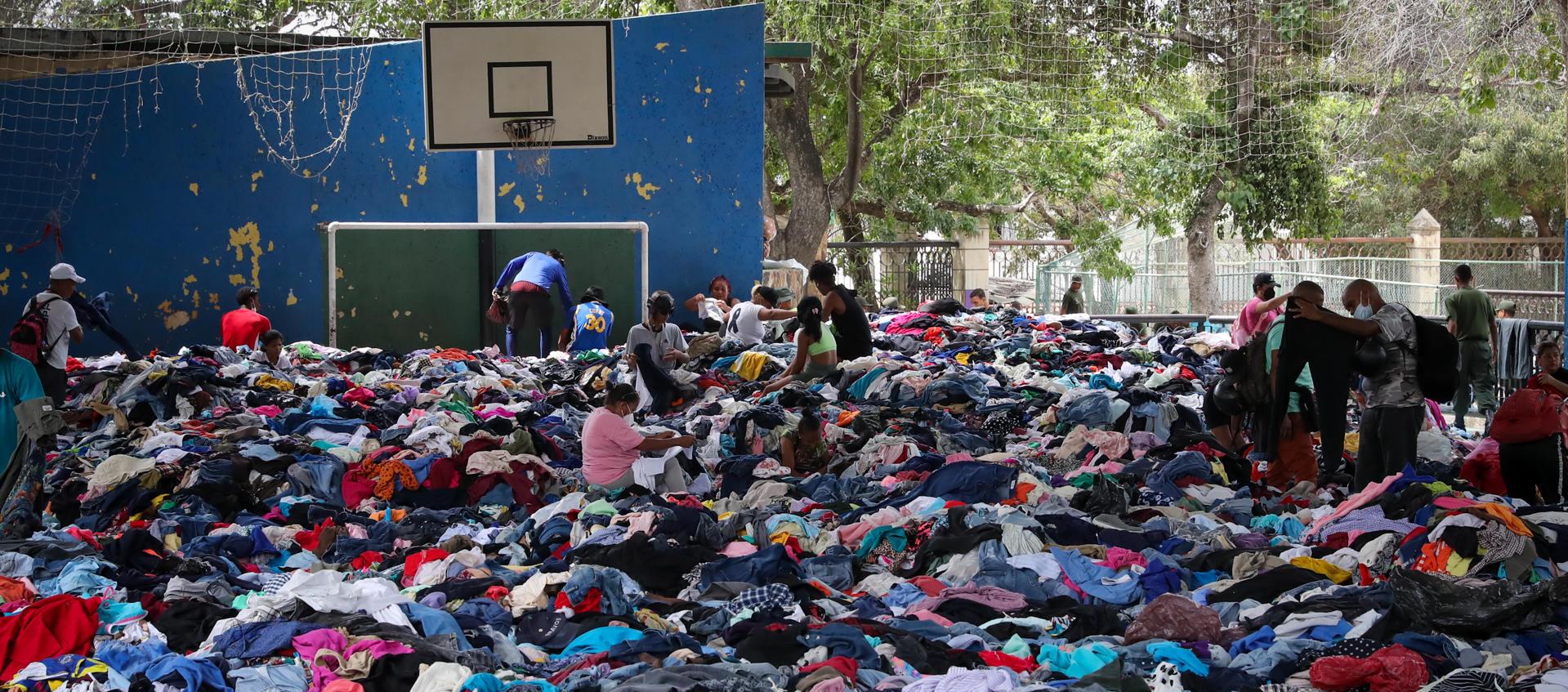 Personas seleccionan ropa en La Guaira, en Venezuela. 