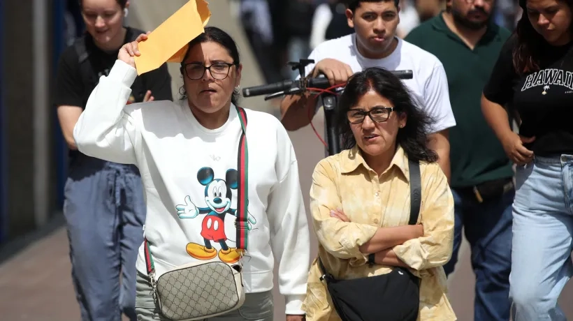 Personas caminan por una calle durante una jornada de altas temperaturas.