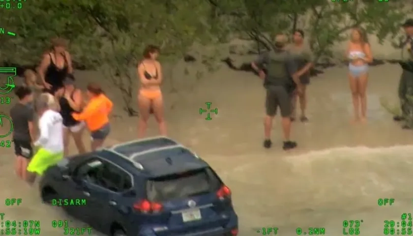 Mujer lleva a orillas de la playa su carro.