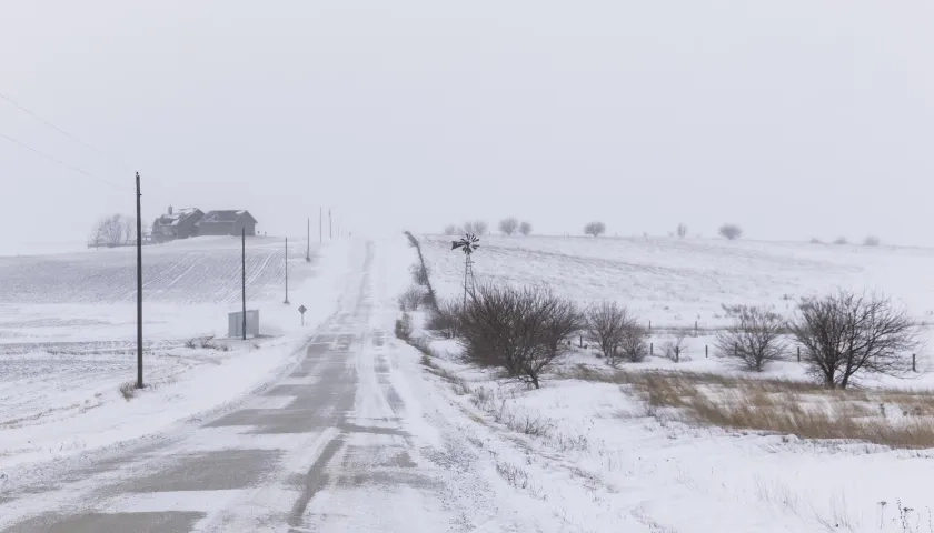 Vista de una calle cubierta con nieve tras una tormenta, en Adair County, Iowa