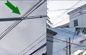 En las imágenes los cables de telefonía en medio de los de energía.