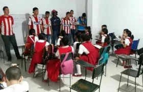 Hinchas llevando los útiles a los pequeños. 