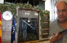 Las personas que ingresaron al restaurante taparon la puerta y vidrio y no dejan ingresar al cónsul Carlos Guerra, en la foto.