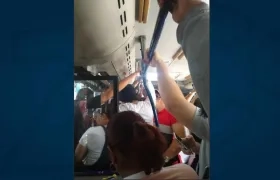 Un bus de Transmetro repleto de pasajeros y sin aire acondicionado.