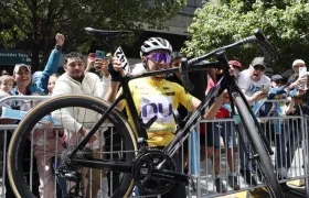 Rodrigo Contreras carga su bicicleta tras coronarse campeón del Tour Colombia. 