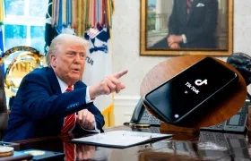 El Presidente de Estados Unidos, Donald Trump/ Logo de la aplicación TikTok en la pantalla de un teléfono.