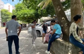 Personas en las afueras de la morgue se cubren ante el putrefacto olor que emana de la parte interior. 