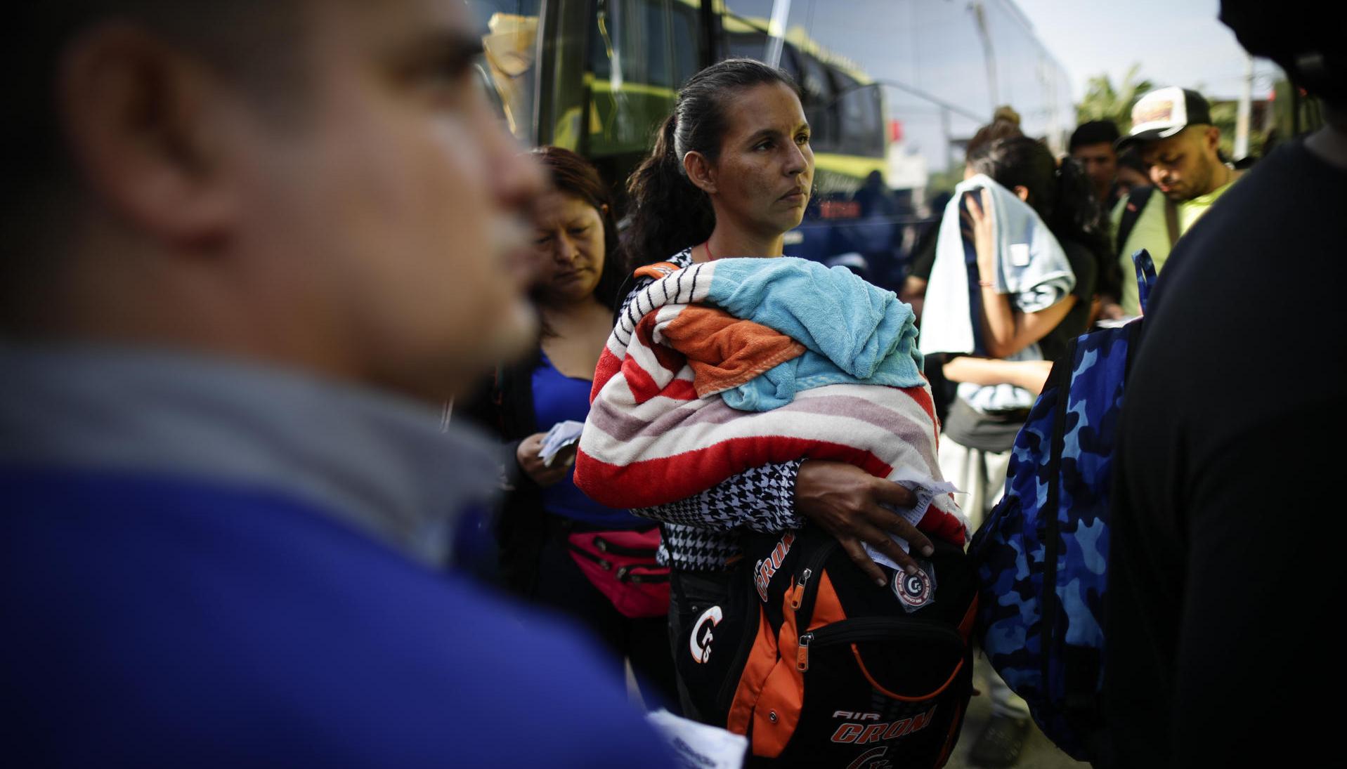 Migrantes venezolanos esperan su traslado en bus hacia Nicaragua en Paso Canoas, población fronteriza entre Panamá y Costa Rica