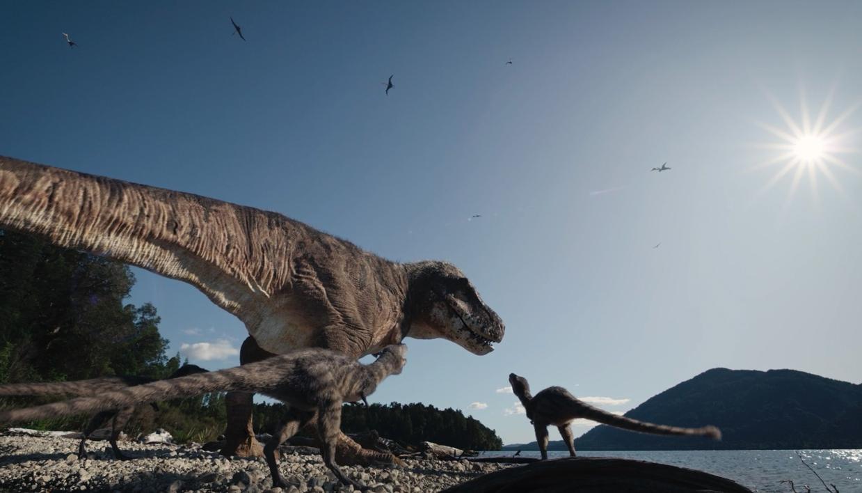 Tiranousario Rex y sus crías junto a un lago.